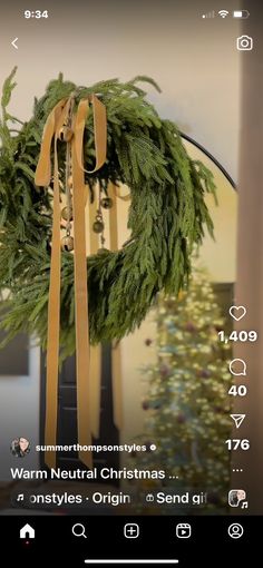 a christmas wreath hanging from the side of a pole