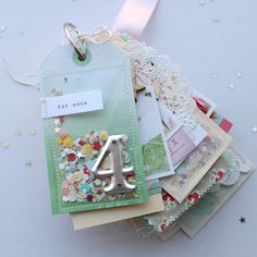 an assortment of cards and tags are arranged on top of each other, including one with the letter a