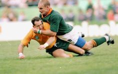 two men are playing rugby on the field