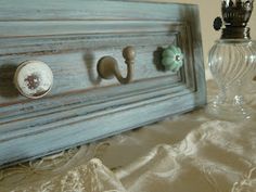 a close up of a drawer with knobs on it and a glass vase next to it