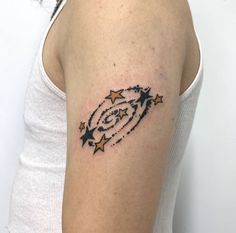 a woman's arm with stars and a spiral design on the left side of her arm