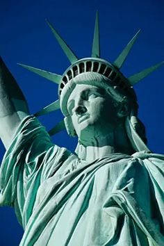 the statue of liberty is shown against a blue sky