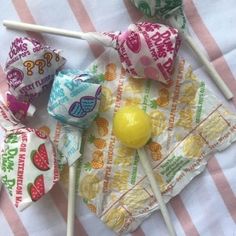 several lollipops on a striped table cloth