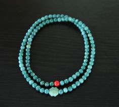 Elevate your wardrobe with this stunning green jade beaded necklace. Hand-threaded with a combination of green jade, clover jade, and cinnabar beads, this piece offers a timeless and versatile look. Perfect for both casual and formal occasions, it's a must-have accessory :)  Condition: Brand new Length: 28" Type of jade: jadeite jade, nephrite jade (clover bead) Color of jade: green bead diameter: 6MM, 0.24" Green Jade Necklace With 108 Beads, Jade Emerald Necklace With Round Beads For Healing, Green Jade Beaded Necklace For Meditation, Spiritual Single Strand Jade Beaded Necklace, Hand-strung Green Jade Beads, Jade Bead Necklace, Nephrite Jade, Jade Beads, Green Jade