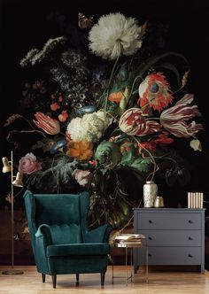 a blue chair sitting in front of a vase filled with flowers