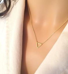 "Before you buy, be sure to get 20% off your order by joining the Balm Designs VIP Club! Just copy and paste this url in a new tab and you will get your instant coupon code: http://bit.ly/BalmDesigns This beautiful necklace is handcrafted using a small silver or gold open triangle pendant that is attached to a delicate and sturdy diamond cut chain. This necklace looks beautiful on its own for its simplicity, but is great for layering with other necklaces! This necklace makes beautiful loved ones Trendy Triangle-shaped Gold Jewelry, Trendy Triangular Gold Jewelry, Trendy Triangle Gold Jewelry, Trendy Gold Triangle Jewelry, Design Vip, Vip Club, Triangle Necklace, Triangle Pendant, Necklace Simple