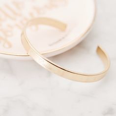 Feel stylish and special with this beautiful personalized cuff bracelet. The unique engraving on the cuff makes this piece truly one-of-a-kind and a must-have accessory for any wardrobe. Are you ready to stand out? Get the Cuff Bracelet today and make a bold statement. Available in 14k gold plated, rhodium plated or 14k rose gold plated brass Width: 1/4" Length: 5 1/2" With engraving this item is FINAL SALE SKU: BYB1018 Gold Bracelet For Women, Bracelet For Women, Rose Gold Plates, Rhodium Plated, Cuff Bracelet, Final Sale, Gold Bracelet, Gold Plate, Cuff