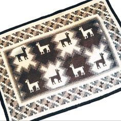 a rug with animals on it is shown in black, white and brown colors as well as an animal pattern