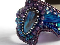 a purple and blue bracelet with beads on it