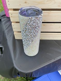 a plastic cup sitting on top of a wooden crate