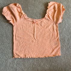 Cropped Baby Tee Never Worn Great Condition Cute Cotton Tops With Floral Print, Sweet Cotton Summer Top, Sweet Crew Neck Top For Spring, Sweet Ruffled Short Sleeve Tops, Cute Cotton Ruffle Top, Sweet Ruffled Tops For Spring, Cute Orange Crew Neck Top, Cute Ruffled Crop Top, Cute Ruffled T-shirt For Spring