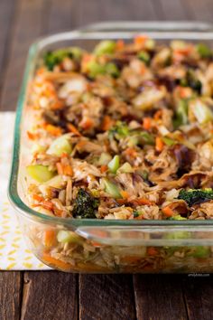 a glass casserole dish filled with rice and vegetables