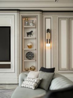 a living room filled with furniture and a flat screen tv mounted to the side of a wall