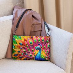 🦚Keep your style on point and your hands free with our Versatile Crossbody/Shoulder Bag Purse with a Unique & Colorful Peacock Design. It's made of premium faux leather and features dark gray hardware. Thanks to the zip-top closure and multiple inside pockets, you can keep your essentials secure and organized. Transform this crossbody bag with removable wrist and shoulder straps to style it for day-to-night looks. * Outer fabric: faux leather  * Lining: 100% polyester * 11″ × 8″ × 1.5″ (27.9 cm × 20.3 cm × 3.8 cm) * Dark gray hardware * Zip-top closure * Inside zip and slip pockets * Adjustable, removable wrist and shoulder straps * Strap drop length: 14″- 27″ Our Other Crossbody Bags: https://www.etsy.com/shop/ZazzFashion?section_id=45645921 Multicolor Satchel Shoulder Bag With Mobile Phone Pocket, Multicolor Crossbody Shoulder Bag With Mobile Phone Bag, Trendy Multicolor Crossbody Clutch, Multicolor Pouch Shoulder Bag For Mobile Phone, Multicolor Crossbody Shoulder Bag With Removable Pouch, Trendy Multicolor Phone Bag For Daily Use, Multicolor Mobile Phone Pouch Shoulder Bag, Multicolor Handheld Shoulder Bag, Multicolor Mobile Phone Pouch Bag