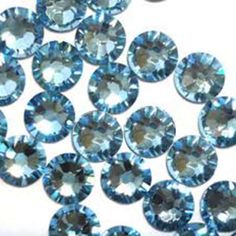 many blue diamonds are shown on a white surface