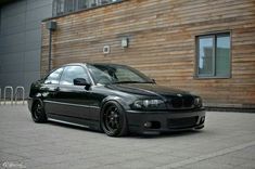 a black car parked in front of a building