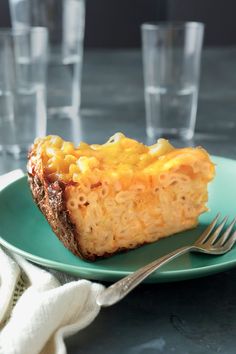 a piece of pie sitting on top of a green plate with a fork next to it