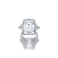 an emerald - cut diamond ring with three diamonds on the band and side stones in white gold