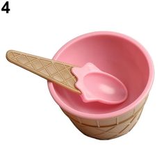 an ice cream scooper with two scoops in it and a spoon inside the cup