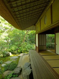 the inside of a japanese house with trees and rocks