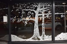 the window is decorated with paper cut trees