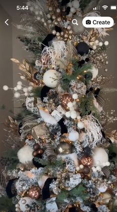 a decorated christmas tree with gold and white ornaments