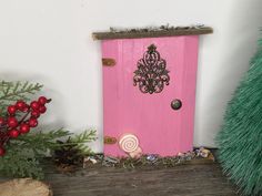 a pink door with a chandelier on it and candy in the foreground