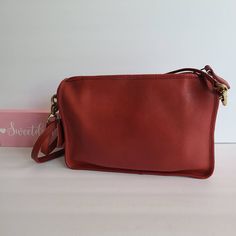 "Vtg Coach Original Companion Bag Red leather with anchor stamp brass hardware Roomy interior with slip pocket Secured by a top Talon Zipper Two front slip pockets Hang tag and ball chain Removable 33.5\" strap Measures: 11\"L, 7.5\"H, 2.5\"W Made in New York City, USA #092-2605 Flaw: discoloration on zipper pull (typical from age) Cleaned, conditioned and ready to wear! Questions? Just ask! More vtg Coach styles/colors available G68a" Red Shoulder Bag With Brass Hardware For Everyday Use, Red Travel Bag With Brass Hardware, Classic Red Shoulder Bag For Travel, Classic Red Bags With Brass Hardware, Red Vintage Shoulder Bag With Gold-tone Hardware, Olive Green Top, Vintage Coach, Tiffany Blue, Custom Bags