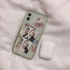 a cell phone case with pictures on it next to an airpods