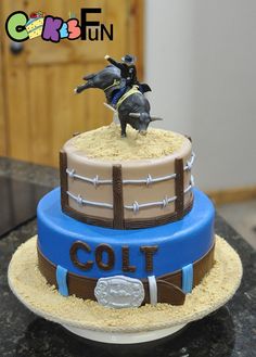 a birthday cake with a horse on top and the words colt written in blue frosting