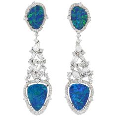 Handcrafted from 18-karat gold, these exquisite drop earrings are set with 8.65 carats Opal and 2.785 carats of glimmering diamonds. FOLLOW MEGHNA JEWELS storefront to view the latest collection & exclusive pieces. Meghna Jewels is proudly rated as a Top Seller on 1stDibs with 5 star customer reviews. All items manufactured by us are handmade and can be customized or redesigned. Composition Size-56X14 MM Total Weight-15.18 Gold Weight(Gms)-12.893 Diamond Wt(Cts)-2.785 Opal Wt(Cts)-8.65 Jewelry Post, Semi Precious Jewelry, White Gold Earrings, Pearl Earrings Dangle, Antique Earrings, Opal Earrings, Gift Jewelry, Dream Jewelry, Opal Jewelry