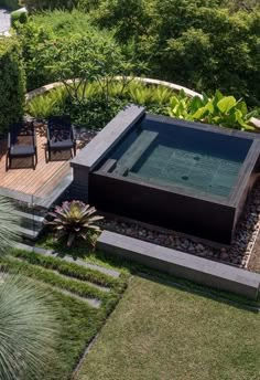 an aerial view of a hot tub surrounded by greenery