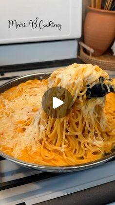 a pan filled with pasta and cheese on top of an oven