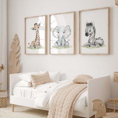 a bedroom with three pictures on the wall and a bed in front of two giraffes