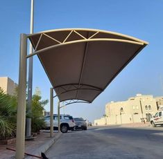 a parking lot with cars parked on the side of it and an awning over them