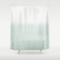 a white shower curtain with a green ombre