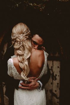 a man and woman embracing each other in front of a wooden wall with the words instagram on it