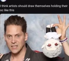 a man holding up a stuffed animal in front of his face and the caption reads, i think artists should draw themselves holding their hands out to look like this