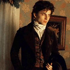 the young man is dressed in period clothing