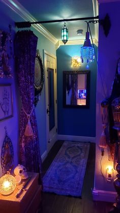 the hallway is lit up with purple lights and decorations on the wall, along with candles