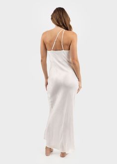 A piece from our Hera collection inspired by ancient Greece and Olympias, it delivers a modern take on traditional designs. A balance of comfort and shape, the Hera slip dress is crafted with clean lines and eco-certified fabrics. Designed with an asymmetric one-shoulder neckline, a fitted bodice and maxi length. Crafted 100 percent from our signature Vegan Cupro fabric for durability, and breathability. Made primarily from Bemberg®, a yarn fiber derived from a by-product of the cotton harvest, Elegant Slip Dress With Straight Neckline And Side Slits, One Shoulder Slip Dress For Summer, Summer One-shoulder Slip Dress, Elegant One Shoulder Summer Slip Dress, One Shoulder Bias Cut Slip Dress, Elegant One-shoulder Summer Slip Dress, One-shoulder Bias Cut Slip Dress, Elegant Asymmetrical Spaghetti Strap Dress, Elegant One Shoulder Dress With Side Slits For Summer