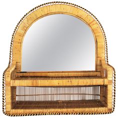 a mirror that is on top of a wicker shelf with a basket underneath it