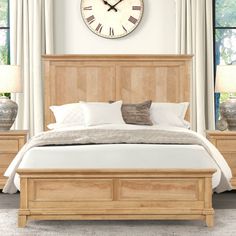 a large clock mounted to the side of a wall above a bed in a bedroom