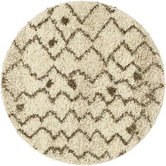 a round rug with brown and white designs on it