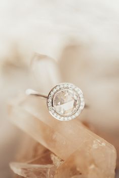 a diamond ring sitting on top of a rock