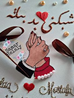 a close up of a piece of art on a table with words and decorations around it