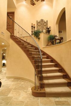 a large foyer with stairs and chandelier