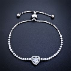 Delicate and elegant, this adjustable heart bracelet will add a touch of sophistication to any wedding gown or formal ensemble. Adorned with heart-shaped cubic zirconia that captures the light from every angle with a perfectly translucent appeal, the bracelet is rhodium / rose gold / yellow gold plated for a flawless finish which perfectly enhances the intricate detailing and conveys a modern take on old elegance. The bracelet measures 0.4" (approx. 1cm) at the widest point, and the adjustable c Wedding Jewelry With Heart Charm In Cubic Zirconia, Cubic Zirconia Heart Charm Jewelry For Wedding, Wedding Jewelry With Cubic Zirconia Heart Charm, Silver Crystal Heart Bracelet For Wedding, Crystal Double Heart Jewelry For Wedding, Anniversary Tennis Bracelet With Adjustable Chain And Cubic Zirconia, Silver Bracelets For Valentine's Day Formal Occasion, Silver Bracelets For Valentine's Day Formal Event, Valentine's Day Silver Bracelet For Formal Occasions