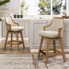 two wooden stools sitting in front of a kitchen counter with an area rug on the floor