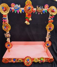 an elaborately decorated display with colorful decorations on it's sides and black background